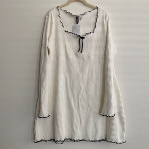 Cream dress with black trim and bow